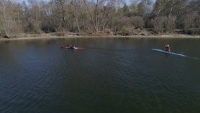 Aerial view of people, floating on kayaks in the river. Drone 4k footage kayaking in the lake.