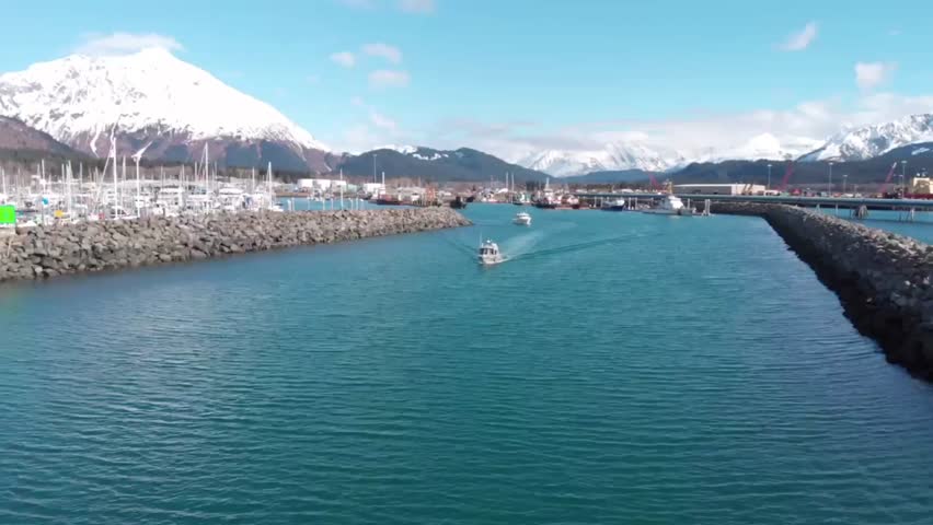 Small boats leaving the Seward Alaska boat harbor to take tourists fishing, sight seeing, and wildlife viewing 