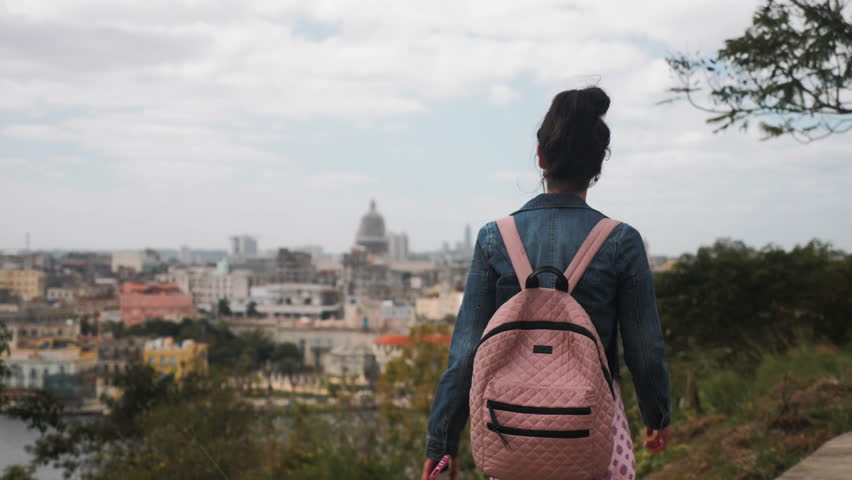 Woman Exploring Havana Cuba, City skyline in Background
