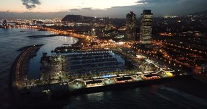Aerial  view in Barcelona city with coast and  urban part of the city at night