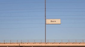 bern railway billboard train passing behind train station signboard