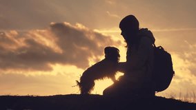 little girl daughter and dog teamwork happy family tourists silhouette concept livestyle holding hands spinning funny video. happy childhood . girl and dog team friendship and care with pets sunset