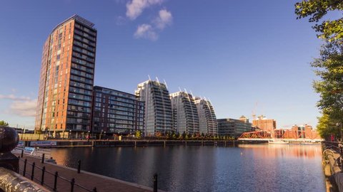 Timelapse overlooking river in Salford Manchester MediaCity with stunning high rise residential buildings with clouds.
