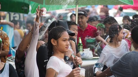 BANCHANG, RAYONG, THAILAND - APRIL 17,2019 : Songkran festival, People and children playing powder and water, water gun, dancing on truck and on the road at Songkran festival in Thailand