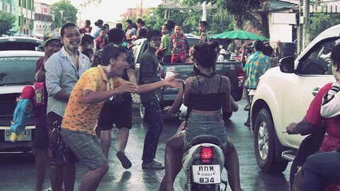 BANCHANG, RAYONG, THAILAND - APRIL 17,2019 : Songkran festival, People and children playing powder and water, water gun, dancing on truck and on the road at Songkran festival in Thailand