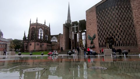 Coventry, West Midlands, UK - April 7, 2019: Low perspective view of Coventry cathedral through a fountain water feature in university square