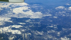Glitch effect. Snowy mountains. View from the airplane
