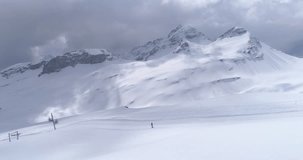 Ovronnaz slopes long panoramic following skiers - Aerial 4K