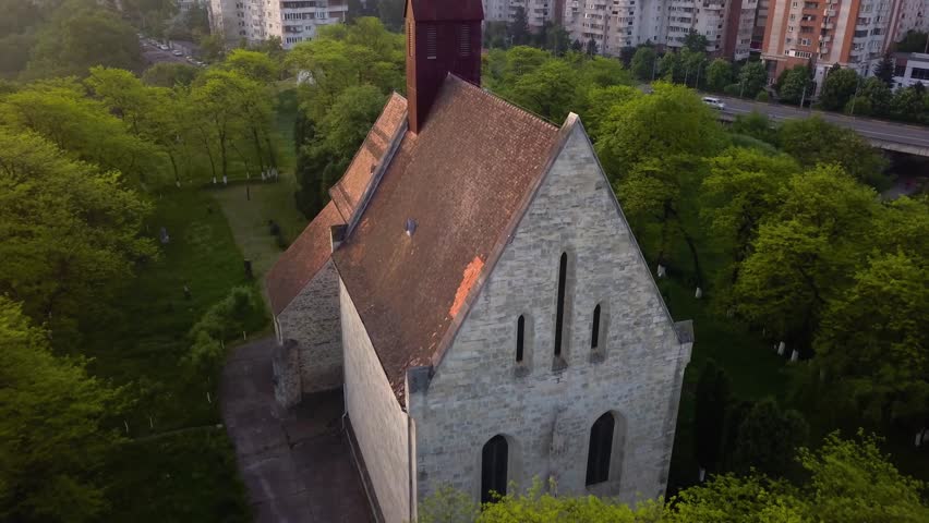 Round View Of Beautiful Church between trees forest And View of monument Town Cluj, Romania, Transylvania.