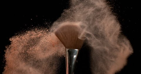 Make-up Brush spreading blush powder on black background, Slow motion 4K