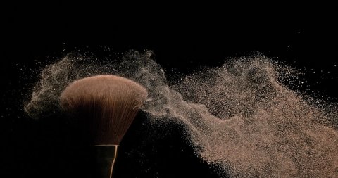 Make-up Brush spreading blush powder on black background, Slow motion 4K