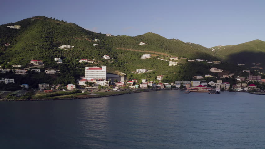 Aerial Pan Right to Left: Coastline with Buildings and Mountain with Homes in San Juan, Puerto Rico