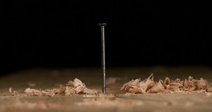 Hammer Pushing a Nail on a Board, Chips of Wood, Slow Motion 4K
