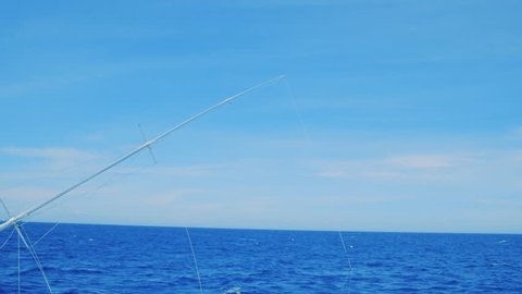 Fishing outrigger deep sea trolling, Curacao, Caribbean, with blue sky and ocean