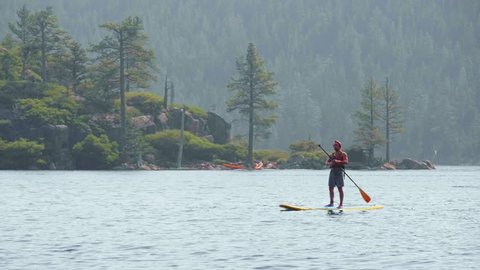 Stand Up Paddleboarder in Emerald Bay Lake Tahoe Tracking Shot