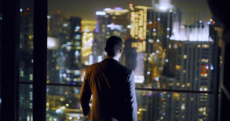 Successful Young Man Standing At Balcony City Skyline Dubai Urban Panorama Fame Night City Lights Slow Motion Red Epic 8k Royalty-Free Stock Footage #1027882874