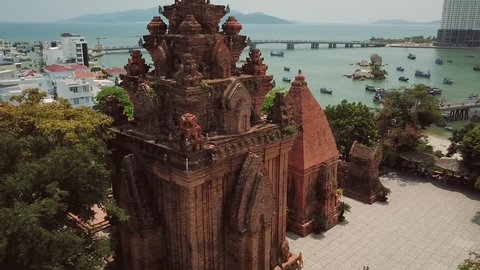 Aerial Po Nagar Cham temple around tower Vietnam Nha Trang exotic cityscape. Modern buildings city bridge active road traffic river fishing old boats. Authentic culture style Asia. Sunny day. Sight