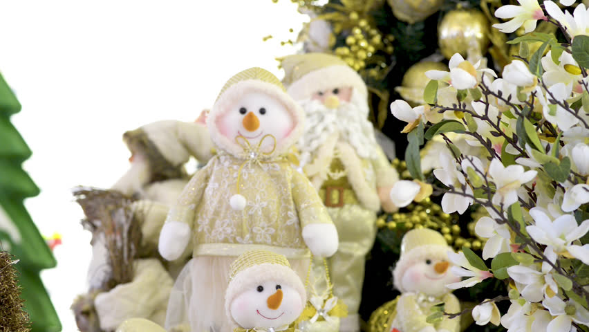 Cute snowmen family dolls and Santa Clauss near Christmas tree and flowers. Panoramic plane