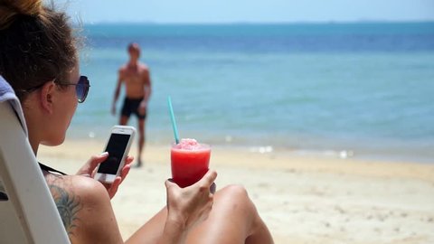 Summer Girl with Smartphone Relaxing on Beach Sun Lounger on Vacation. HD, 1920x1080.
