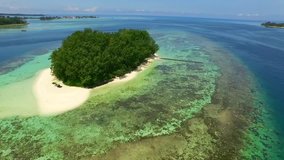 JAKARTA, INDONESIA. A remote island within Indonesian landscape. Aerial view of a tropical hideaway with powder-white beaches and pristine coral reefs.