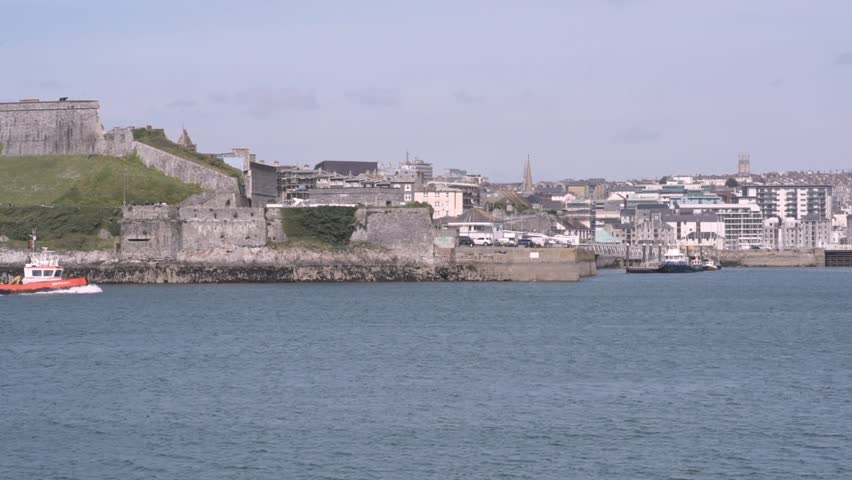 Tug Tugboat. Little Orange Tug-boat passing by in the Port of Plymouth Barbican Harbour Devon England UK