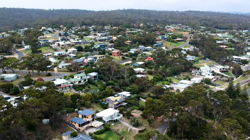 Aerial reveal shot of rural seaside town in Tasmania, Australia