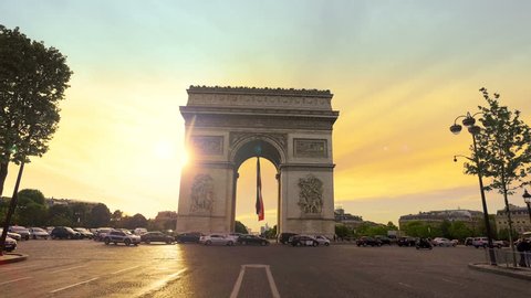 Traffic in front of the Arc de Triomphe in Paris at susnet, cinematic steadicam hyperlapse