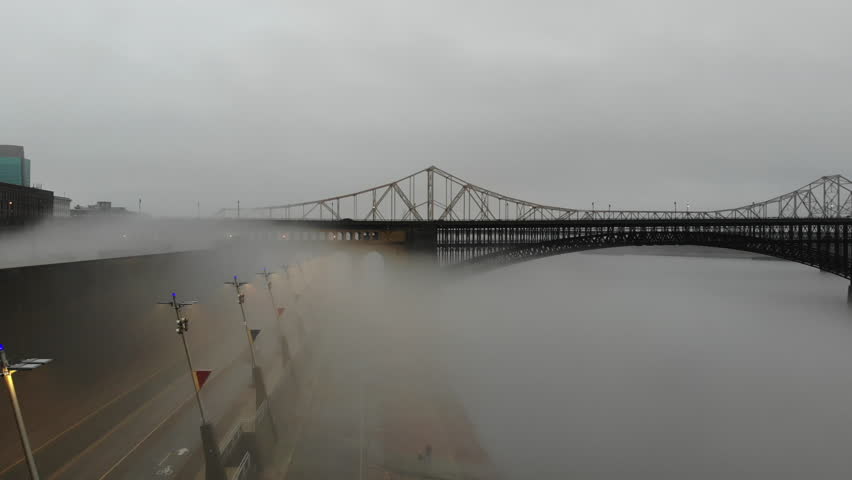 Slow aerial push through the fog toward Eads Bridge in St. Louis, Missouri.