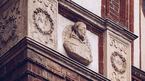 Footage of ancient Italian catholic church facade with stone monument on wall.Very old christian temple build in classic baroque style in Milano, Italy