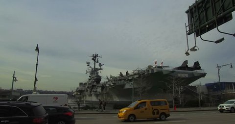 New York, NY/USA - March 25, 2019: driving Northbound down the West Side Highway in New York City and seeing the USS Intrepid Aircraft Carrier. 