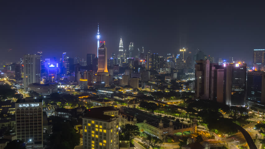 Time lapse: Midnight view of Kuala Lumpur city skyline with busy light trails in Malaysia at midnight. Zoom out motion timelapse. | Shutterstock HD Video #1027934123