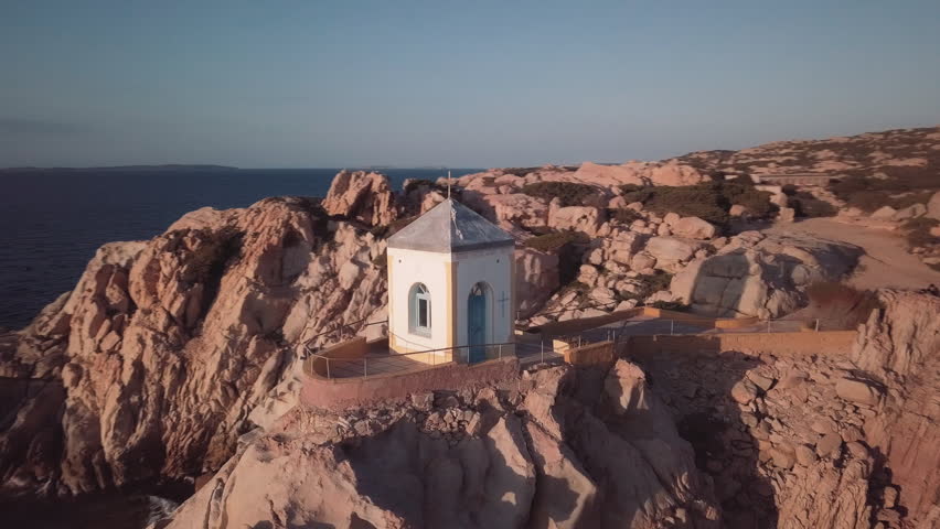 Aerial of a chapel on water. Camera turn around the subject. FullHD