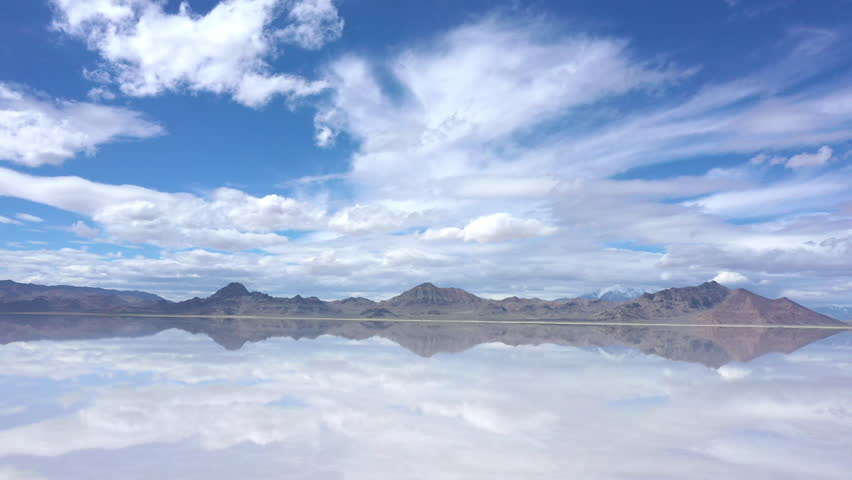 View of clouds reflecting in water over the Bonneville Salt Flats as water covers the landscape in Utah during Spring.