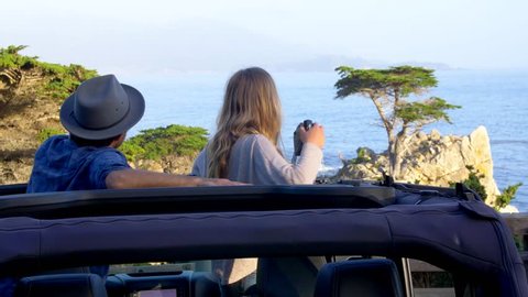 Big Sur, CA / USA - July 16 2017: Couple Stops at Lone Cypress Tree in Jeep