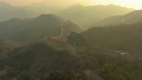 Tower of Great Wall of China and Green Mountains at Sunset. Badaling. Aerial View. Drone is Orbiting. Wide Shot
