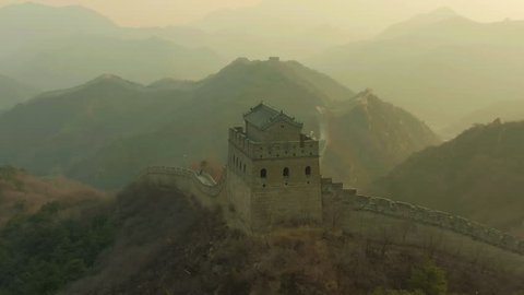 Tower of Great Wall of China and Green Mountains at Sunset. Badaling. Aerial View. Drone is Orbiting. Medium Shot