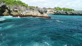 Aerial View of Flying out between two Cliffs over Waves in Blue Lagoon Bali with Drone 4k Camera - Fly Out - Vibrant Drone Video