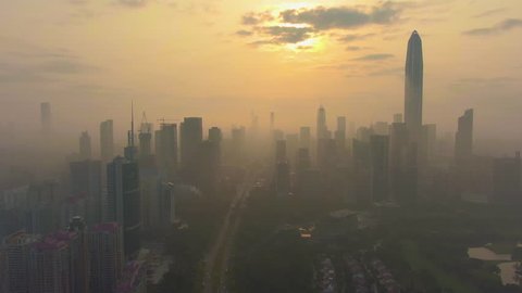 Shenzhen Urban Skyline in Misty Morning. Skyscrapers of Futian District. China. Aerial View. Drone Flies Sideways and Upwards, Camera Tilts Up