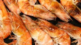 Closeup cooking shrimps in pan clips.
