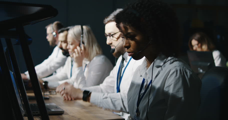 Medium shot of technicians cheering in the mission control room