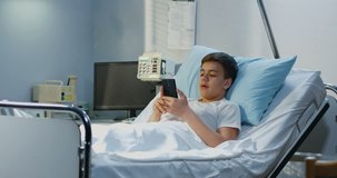 Medium shot of injured teenager using video call in hospital room