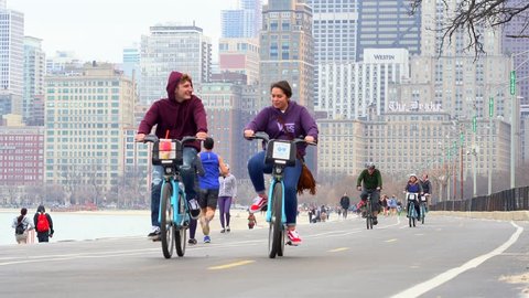 Chicago, Illinois: April 17, 2019 locals and tourists exercising along the lake Michigan shore