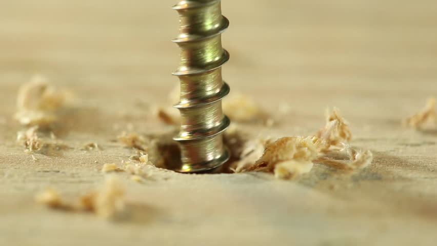 Extreme close up of drilling into wood with screw twisted into place. Royalty-Free Stock Footage #1027969877