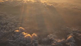 Transportation Video Aerial view from the aircraft window while flying through the cloud with golden light from the sun in the early morning or evening in travel and transportation concept