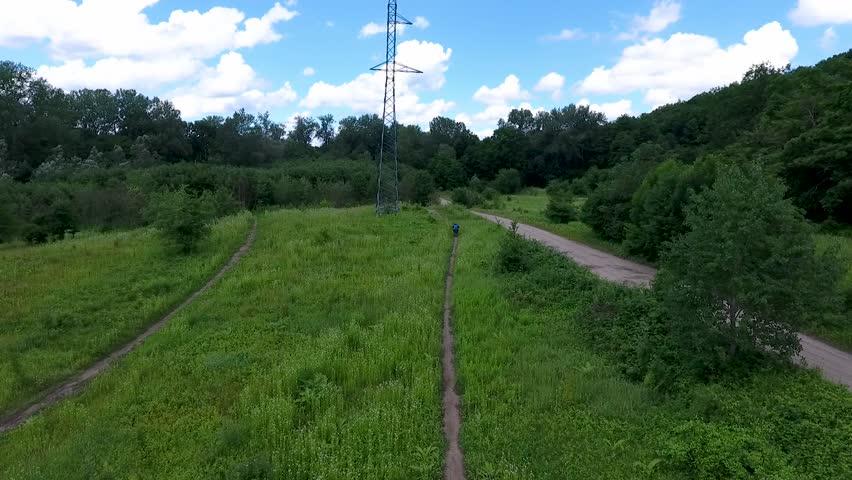 The rider is training on a forest track. Aerial view.
