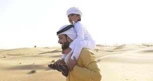 Happy father and son spending time in the desert playing and doing activities