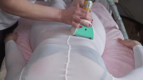 Specialist makes healthy vacuum roller LPG massage close up