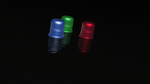 Three color thimbles on black backgrounds - metaphor.