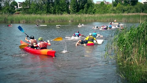 VILNIUS, LITHUANIA - JUNE 04, 2016: Active sporty people floating on lake in water sport competition. 4K