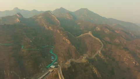 Great Wall of China at Sunny Evening in Haze. Badaling. Aerial View. Drone Flies Forward and Downwards
